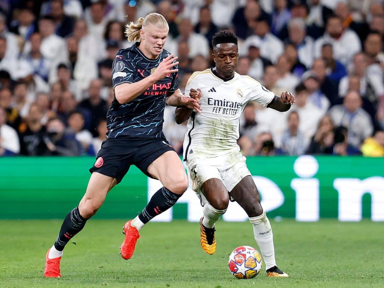 Vinícius Jr. del Real Madrid e Erling Haaland del Manchester City in azione durante una partita di Champions League